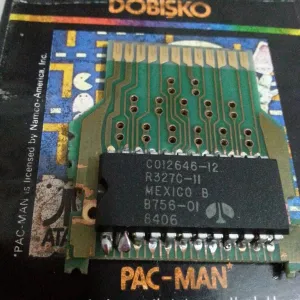 A photo showing the PCB and ROM chip of a Pac-Man cartridge manufactured in Turkey. One can see something unusual about two adjacent pins leading from the ROM to the PCB.