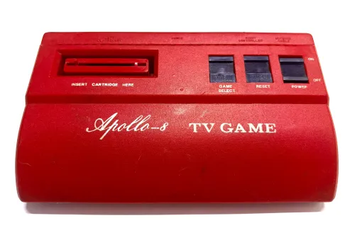 Top down photo of a red Atari clone against a white background 